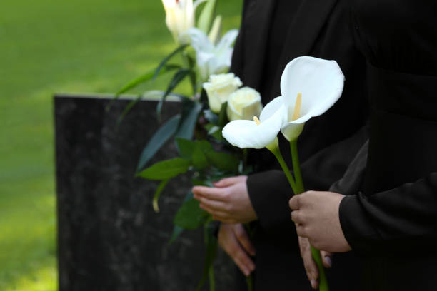 People with flowers outdoors, closeup. Funeral ceremony People with flowers outdoors, closeup. Funeral ceremony